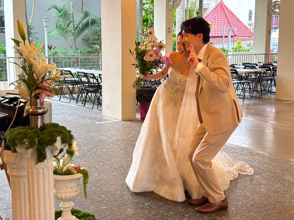 Bride and groom posing together at their wedding reception