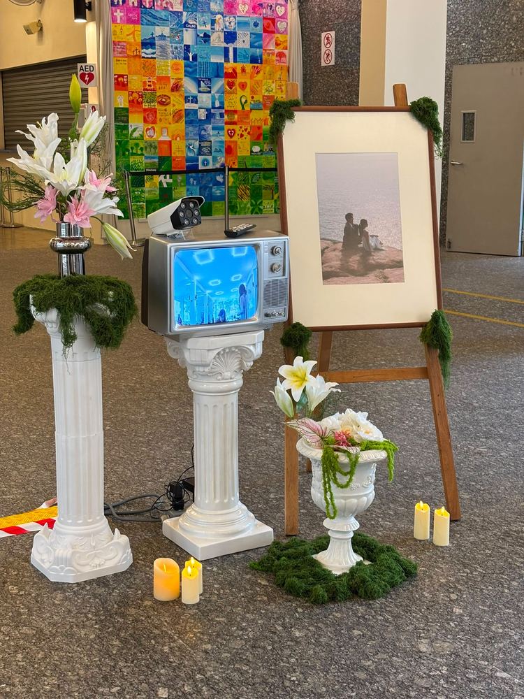 Vintage TV set styled with columns and flowers at a wedding